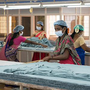 workers cutting cloth for clothes