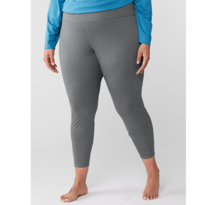 Woman in REI Co-op branded leggings, available in plus sizes.